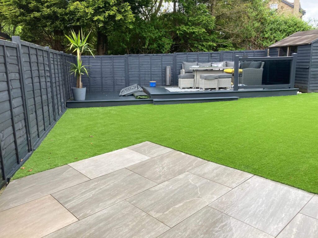 Photo of the same garden above but, with an installation of artificial grass. 