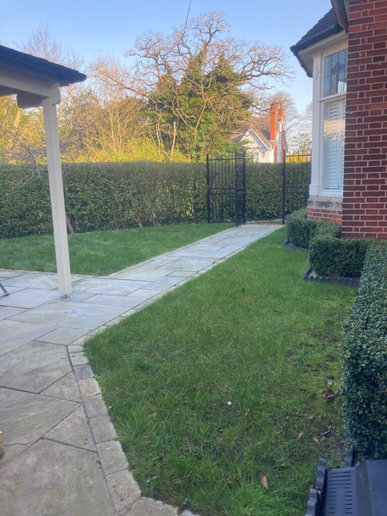 Photo of a garden before with two scruffy grass areas