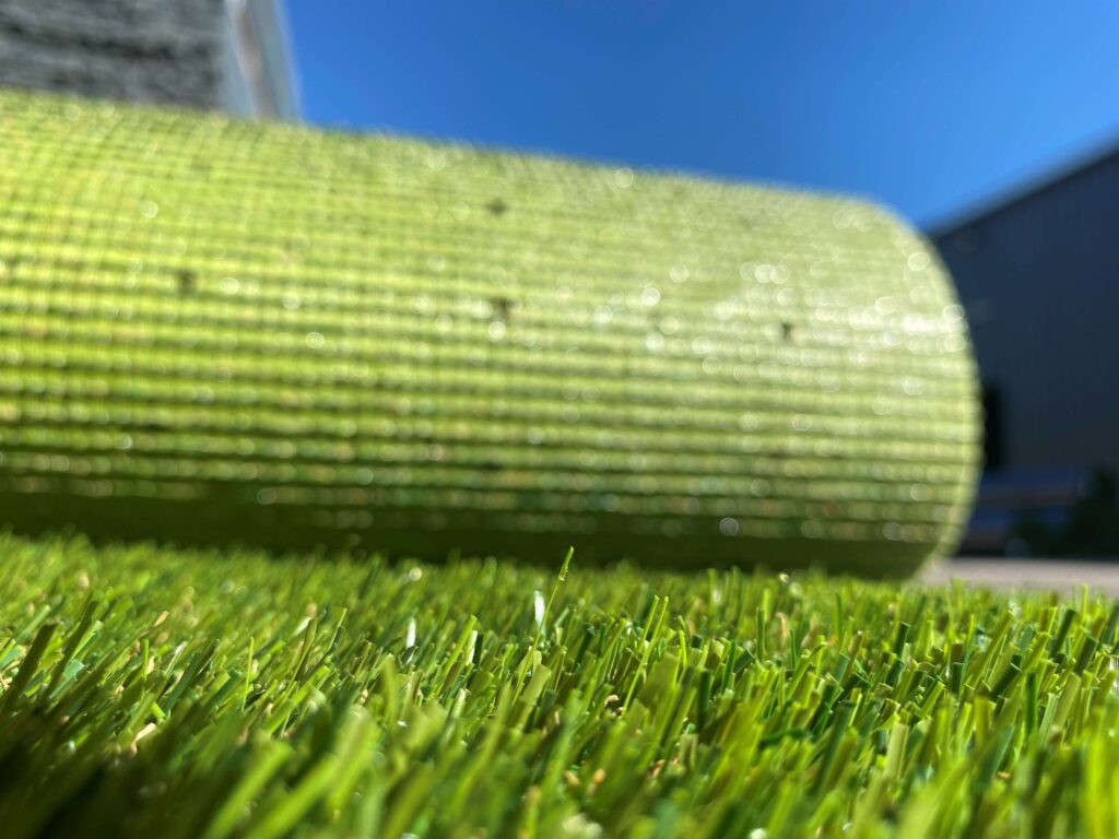 Photo of an environmentally friendly artificial grass roll with focus on the fibres