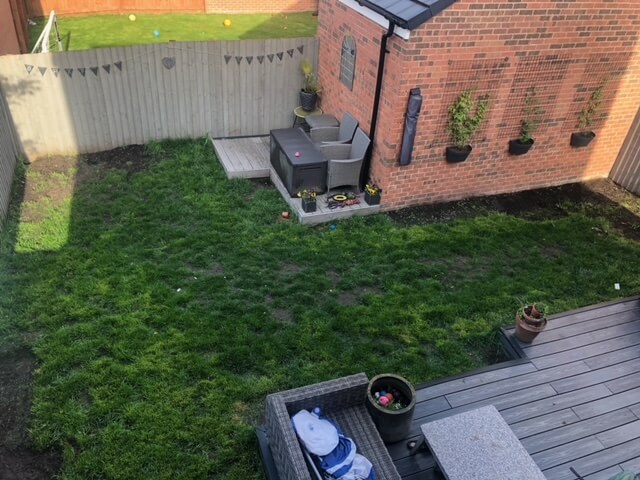 Photo of the garden with a patchy lawn, before the dog damage lawn repair.