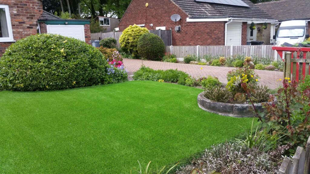 Photo of a front garden looking vibrant with artificial grass.