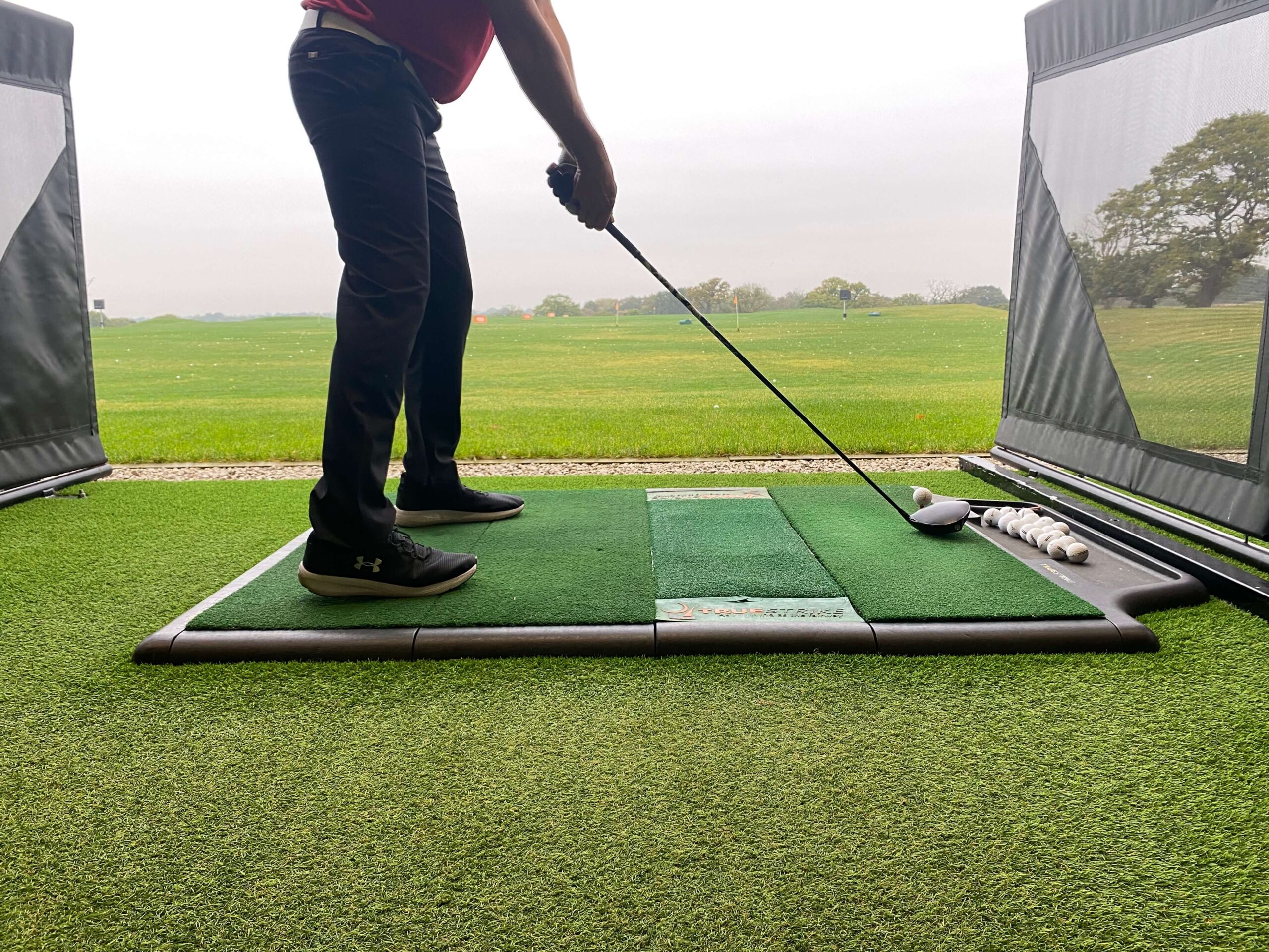 Photo of golfer using an artificial grass driving range.