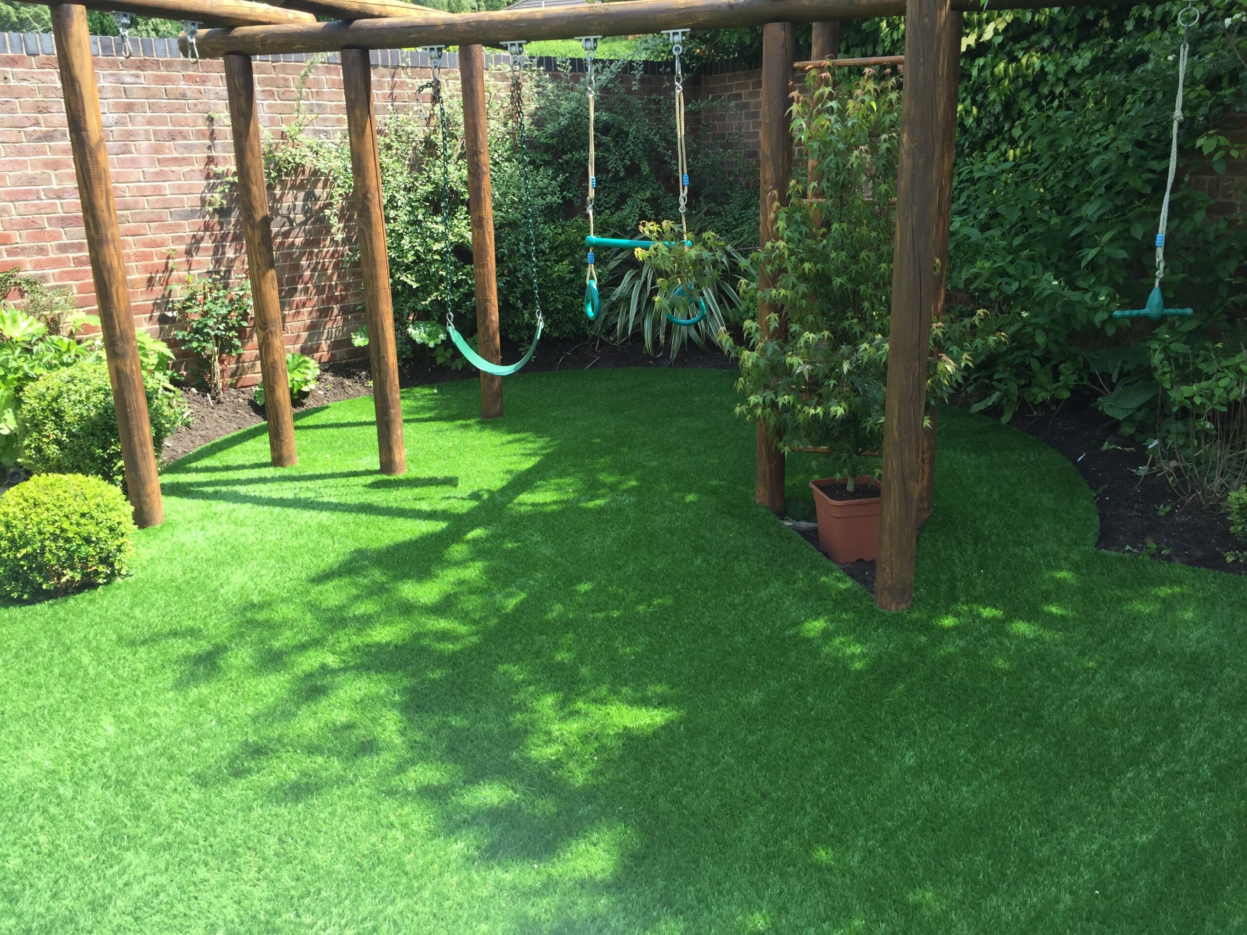 Photo of climbing frame and artificial grass for kids.