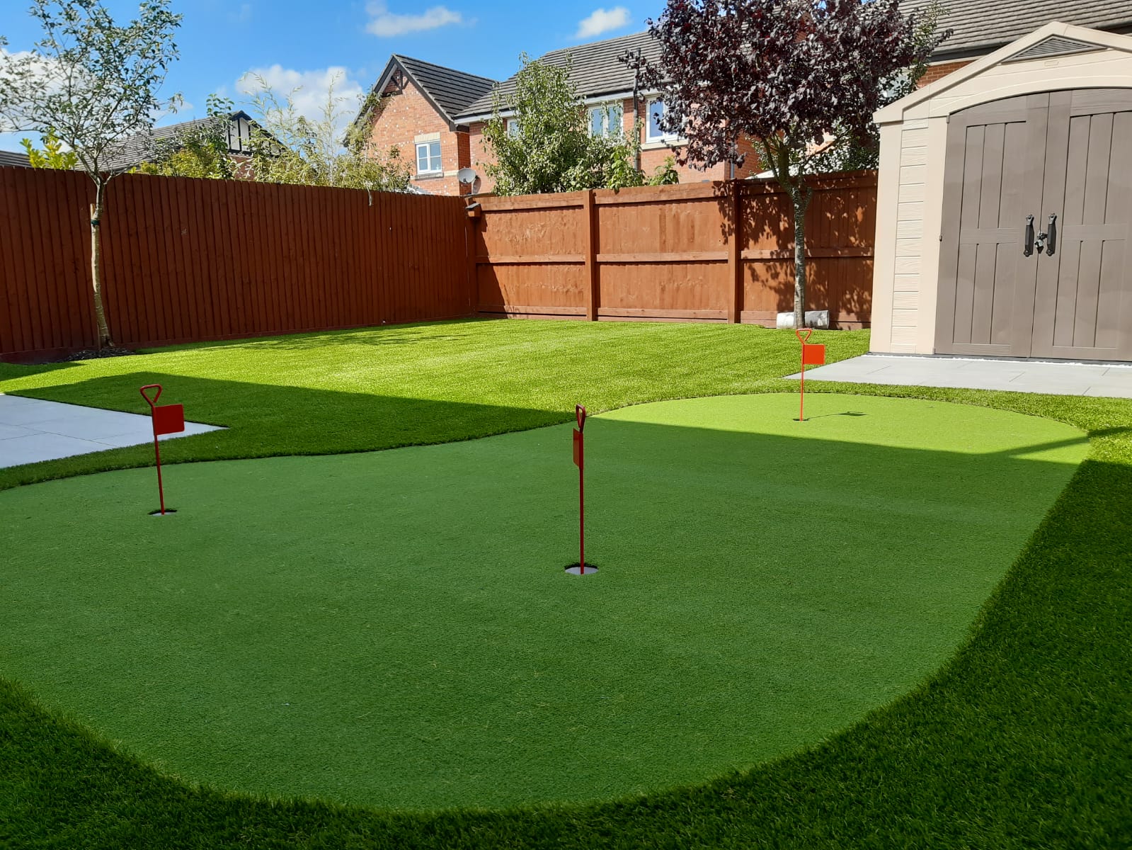 Artificial grass putting green with flags in the holes