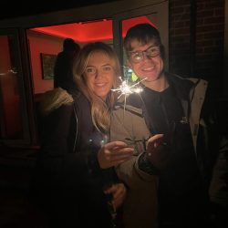 2 people holding sparklers on bonfire night